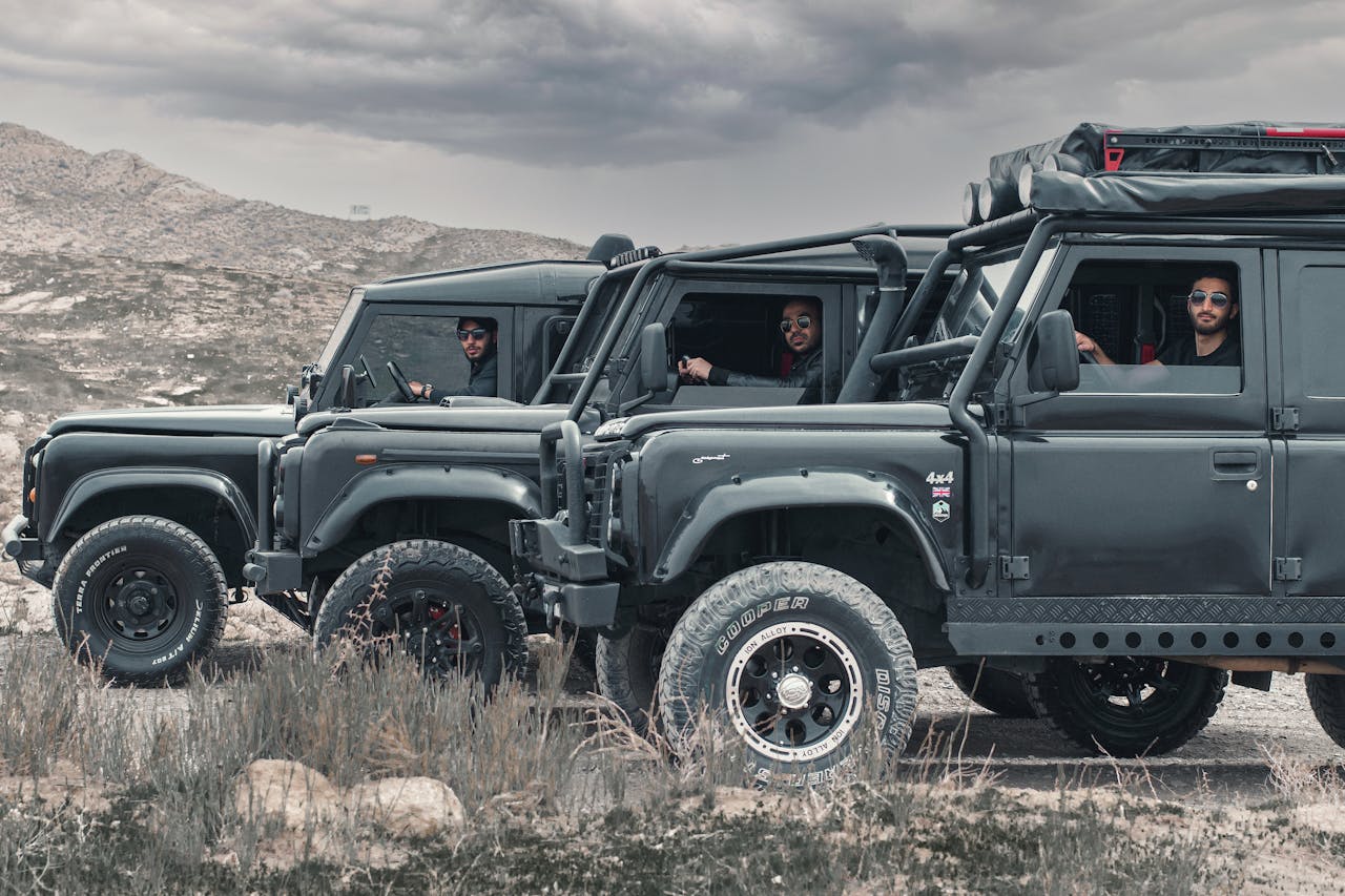 Three SUVs lined up for an off-road adventure in Mashhad's rugged terrain.